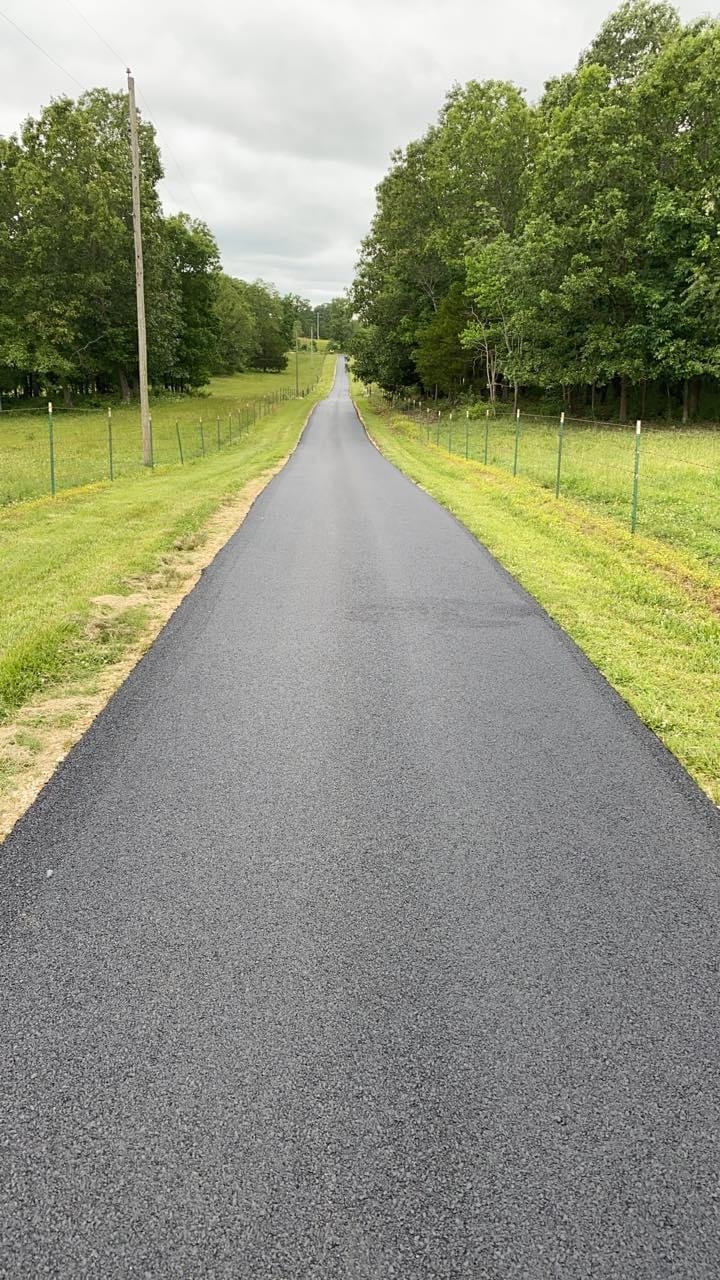 Long paved driveway with stone border on an eastside property